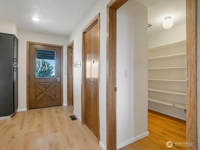 2 W Johnson Ln, Lind, WA 99341 - doorway to outside with light wood-style flooring and baseboards