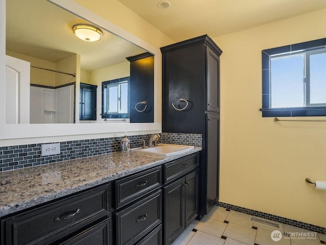 2 W Johnson Ln, Lind, WA 99341 - full bathroom with tasteful backsplash, vanity, tile patterned flooring, and a shower