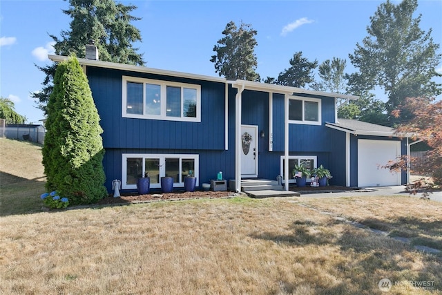 5701 38th Ct SE, Lacey, WA 98503 - bi-level home with a front yard, a chimney, and a garage