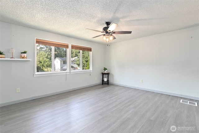 5701 38th Ct SE, Lacey, WA 98503 - unfurnished room featuring wood finished floors, a ceiling fan, and a textured ceiling