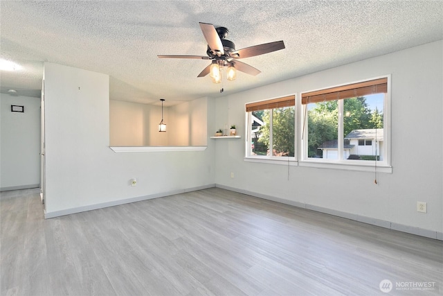 5701 38th Ct SE, Lacey, WA 98503 - empty room with wood finished floors, a textured ceiling, and ceiling fan