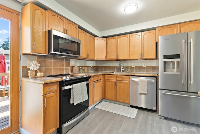 5701 38th Ct SE, Lacey, WA 98503 - kitchen with stainless steel appliances, light wood finished floors, and tasteful backsplash