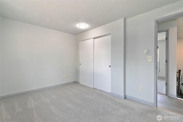 5701 38th Ct SE, Lacey, WA 98503 - unfurnished bedroom with light carpet, a textured ceiling, and a closet