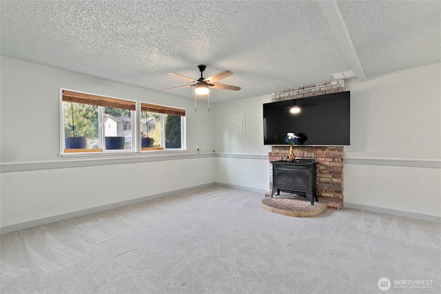 5701 38th Ct SE, Lacey, WA 98503 - unfurnished living room with a ceiling fan, a textured ceiling, carpet floors, and a wood stove