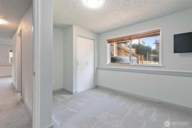 5701 38th Ct SE, Lacey, WA 98503 - unfurnished bedroom featuring a textured ceiling, carpet, and a closet