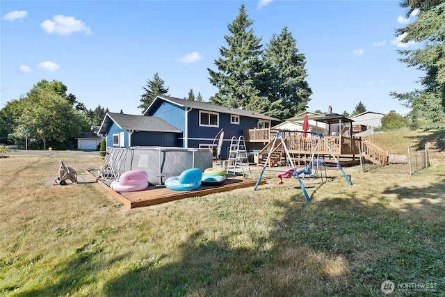 5701 38th Ct SE, Lacey, WA 98503 - back of property featuring a playground, a lawn, and a wooden deck