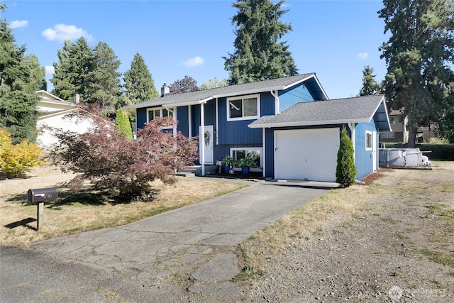 5701 38th Ct SE, Lacey, WA 98503 - split foyer home with an attached garage, asphalt driveway, and a chimney