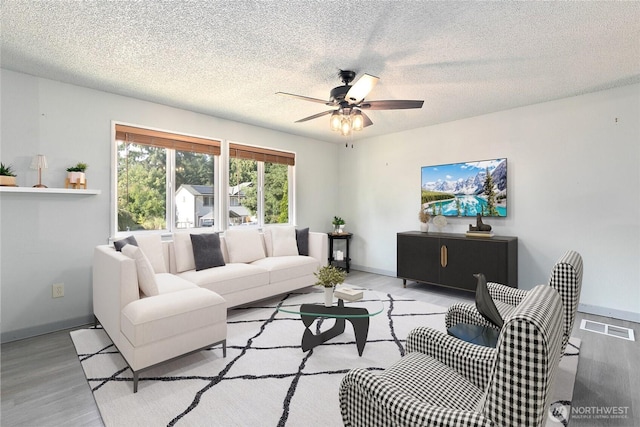 5701 38th Ct SE, Lacey, WA 98503 - living area with wood finished floors, ceiling fan, and a textured ceiling