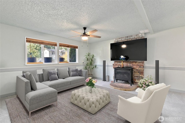 5701 38th Ct SE, Lacey, WA 98503 - living room featuring a textured ceiling, ceiling fan, a wood stove, and carpet floors
