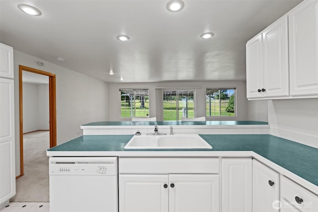 19214 Lakeview Dr, Soap Lake, WA 98851 - kitchen featuring white dishwasher, recessed lighting, a peninsula, white cabinets, and light carpet