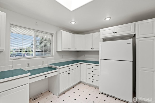 19214 Lakeview Dr, Soap Lake, WA 98851 - kitchen with freestanding refrigerator, white cabinets, and recessed lighting