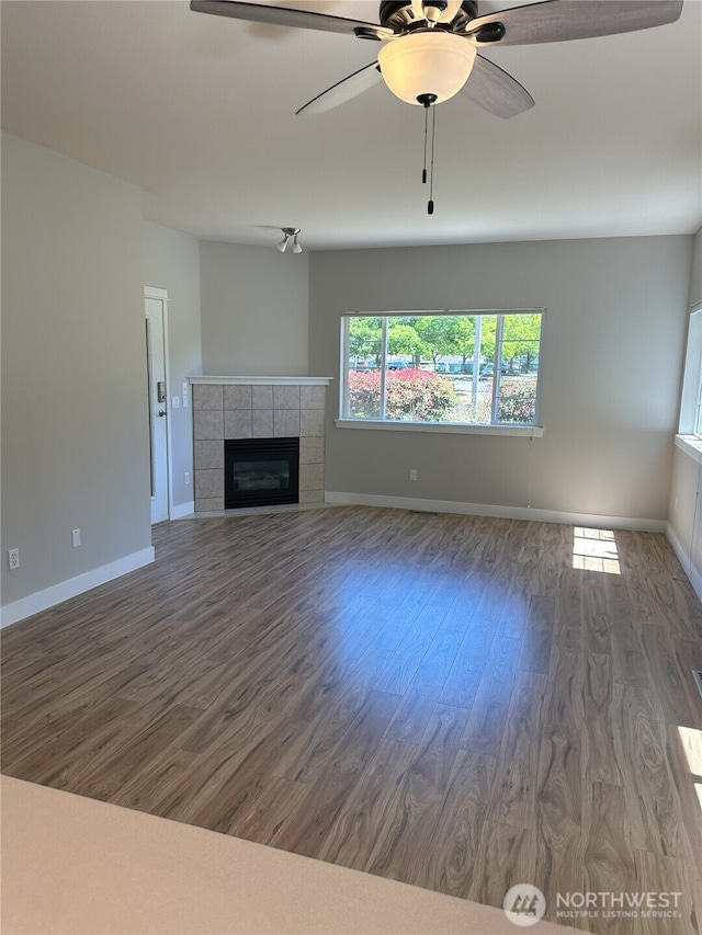 515 W Kellogg Rd, Bellingham, WA 98226 - unfurnished living room with wood finished floors, a tile fireplace, and ceiling fan
