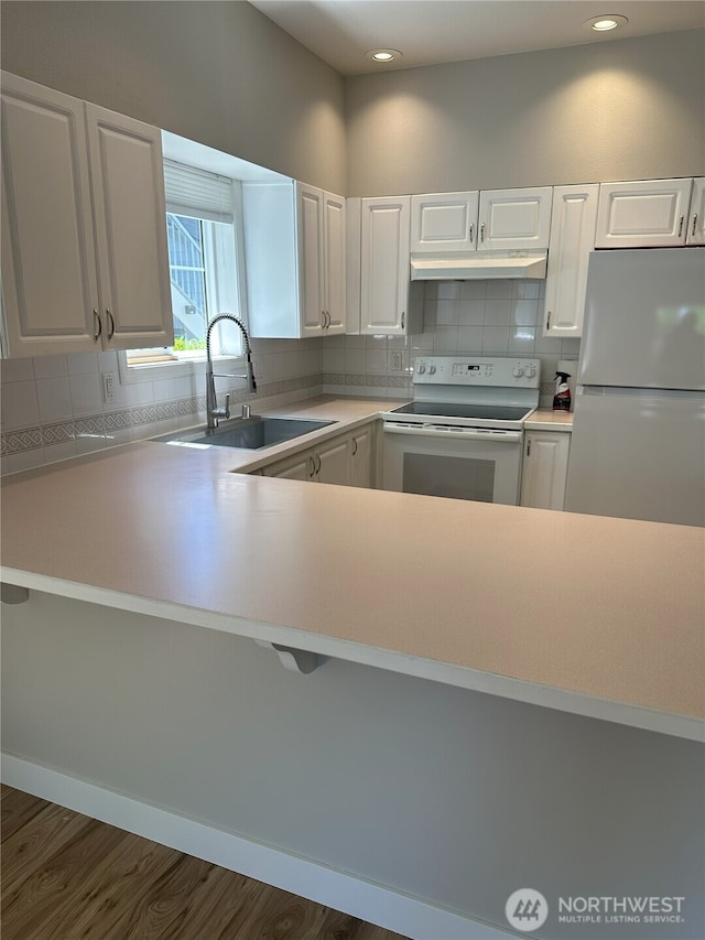 515 W Kellogg Rd, Bellingham, WA 98226 - kitchen featuring white appliances, under cabinet range hood, decorative backsplash, white cabinets, and recessed lighting