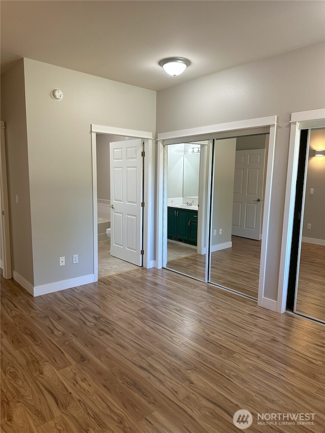 515 W Kellogg Rd, Bellingham, WA 98226 - unfurnished bedroom with wood finished floors and ensuite bath