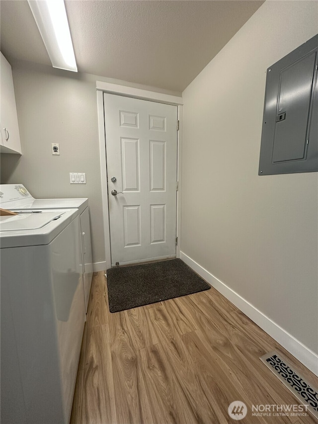 515 W Kellogg Rd, Bellingham, WA 98226 - washroom with electric panel, cabinet space, washer and dryer, light wood-type flooring, and a textured ceiling