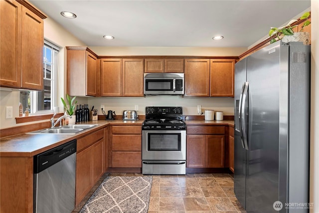 300 Saddlehorn Ln, Wenatchee, WA 98801 - kitchen with appliances with stainless steel finishes, brown cabinets, and recessed lighting