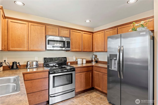 300 Saddlehorn Ln, Wenatchee, WA 98801 - kitchen with stainless steel appliances, recessed lighting, light countertops, and brown cabinets