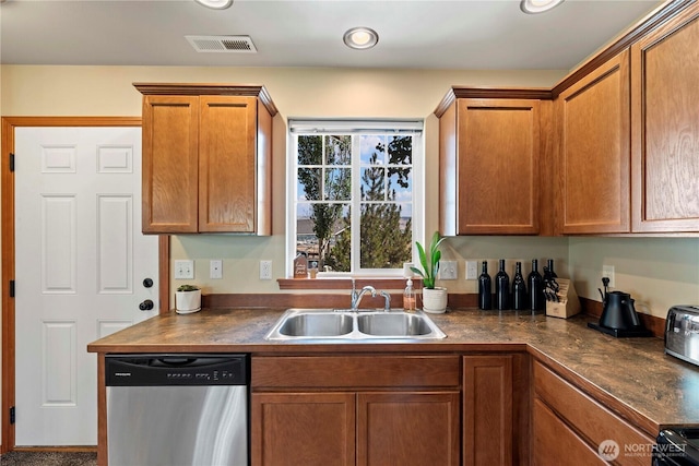 300 Saddlehorn Ln, Wenatchee, WA 98801 - kitchen with stainless steel dishwasher, dark countertops, brown cabinetry, and recessed lighting