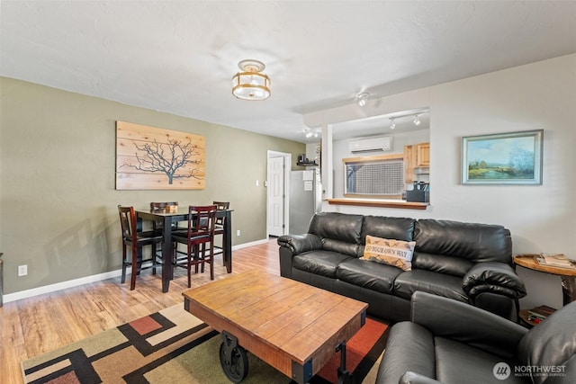 1313 Front St, Leavenworth, WA 98826 - living room featuring a wall mounted air conditioner and light wood-style floors