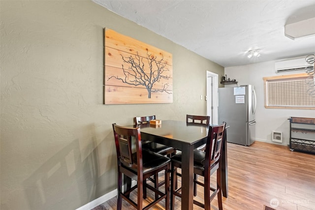 1313 Front St, Leavenworth, WA 98826 - dining room featuring a wall mounted air conditioner and wood finished floors