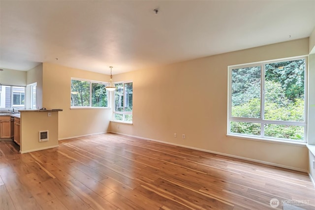 3924 243rd Pl SE Unit G204, Bothell, WA 98201 - unfurnished living room with baseboards and light wood-style flooring