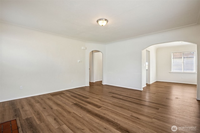 3154 Pear St SE, Olympia, WA 98501 - empty room featuring arched walkways and wood finished floors