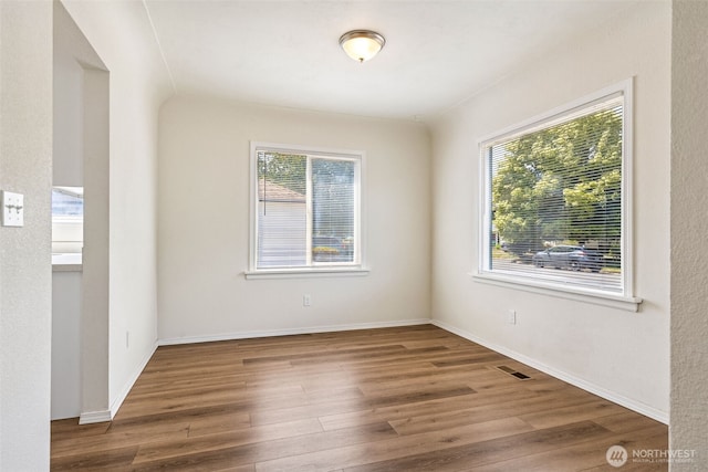 3154 Pear St SE, Olympia, WA 98501 - spare room featuring healthy amount of natural light and wood finished floors