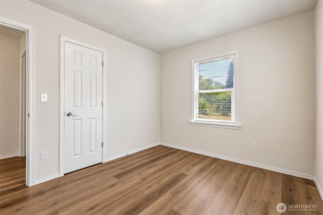 3154 Pear St SE, Olympia, WA 98501 - empty room featuring wood finished floors and a textured ceiling