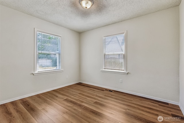 3154 Pear St SE, Olympia, WA 98501 - spare room with wood finished floors and a textured ceiling