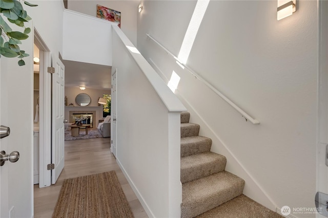 25015 110th Ave SE Unit B, Kent, WA 98030 - staircase featuring a fireplace, a towering ceiling, and wood finished floors