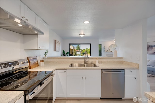 25015 110th Ave SE Unit B, Kent, WA 98030 - kitchen with stainless steel appliances, under cabinet range hood, white cabinets, light countertops, and a textured ceiling