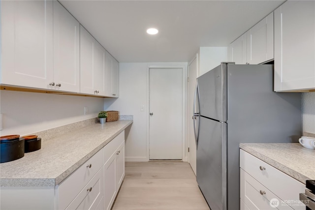 25015 110th Ave SE Unit B, Kent, WA 98030 - kitchen featuring light wood-type flooring, light countertops, white cabinets, freestanding refrigerator, and recessed lighting