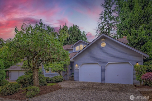 14111 NE 63rd Ct, Redmond, WA 98052 - view of front of home with driveway, a garage, roof with shingles, and a chimney