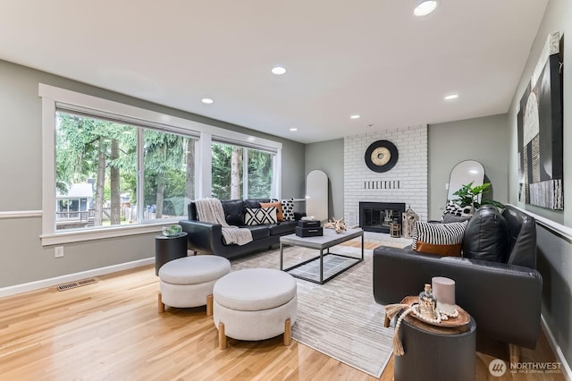 14111 NE 63rd Ct, Redmond, WA 98052 - living room with wood finished floors, plenty of natural light, a fireplace, and recessed lighting
