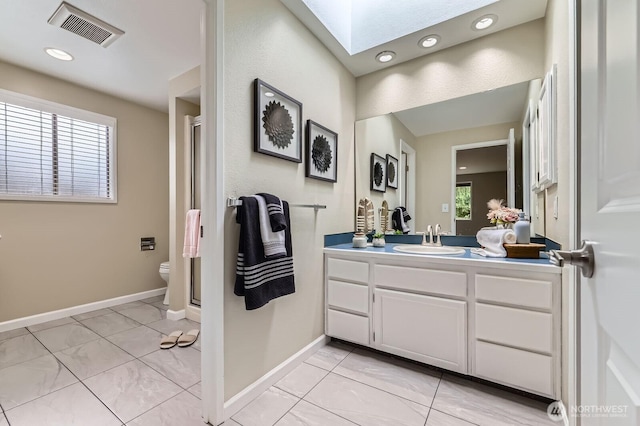 14111 NE 63rd Ct, Redmond, WA 98052 - full bath featuring a skylight, vanity, a shower stall, and recessed lighting