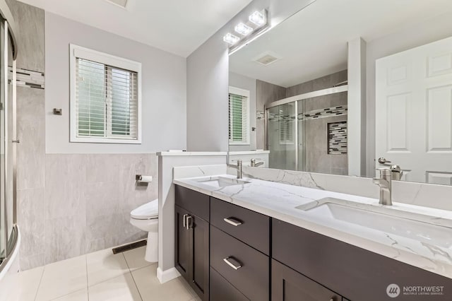 14111 NE 63rd Ct, Redmond, WA 98052 - full bathroom featuring tile walls, a stall shower, double vanity, plenty of natural light, and tile patterned flooring