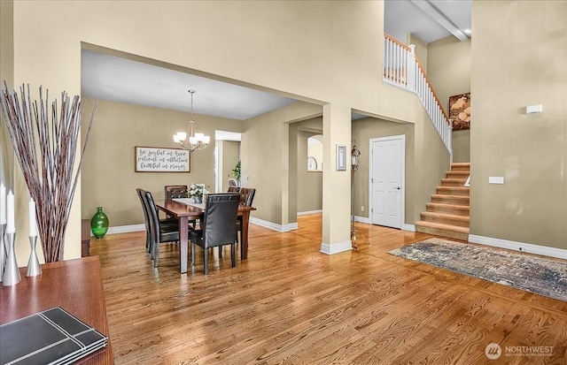 25004 163rd Pl SE, Covington, WA 98042 - dining room featuring a chandelier, light wood finished floors, stairway, and a high ceiling