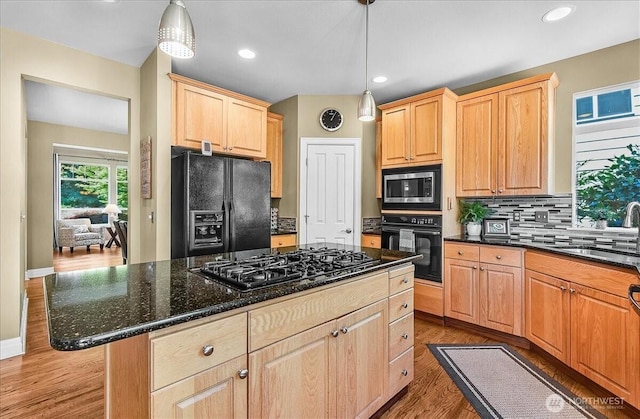 25004 163rd Pl SE, Covington, WA 98042 - kitchen featuring black appliances, light brown cabinets, tasteful backsplash, wood finished floors, and hanging light fixtures