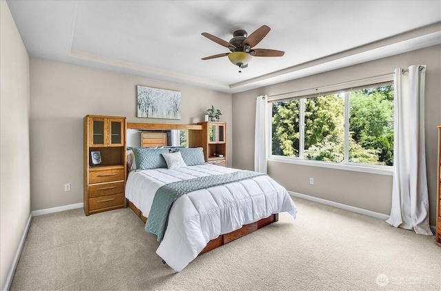 25004 163rd Pl SE, Covington, WA 98042 - bedroom with light colored carpet, a raised ceiling, and a ceiling fan