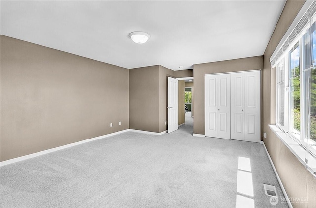 25004 163rd Pl SE, Covington, WA 98042 - unfurnished bedroom with light colored carpet, multiple windows, and a closet