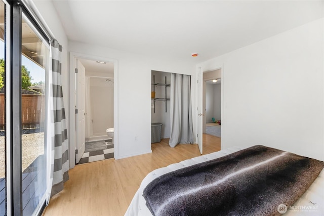 8851 48th Pl W, Mukilteo, WA 98275 - bedroom featuring light wood finished floors, connected bathroom, and access to outside