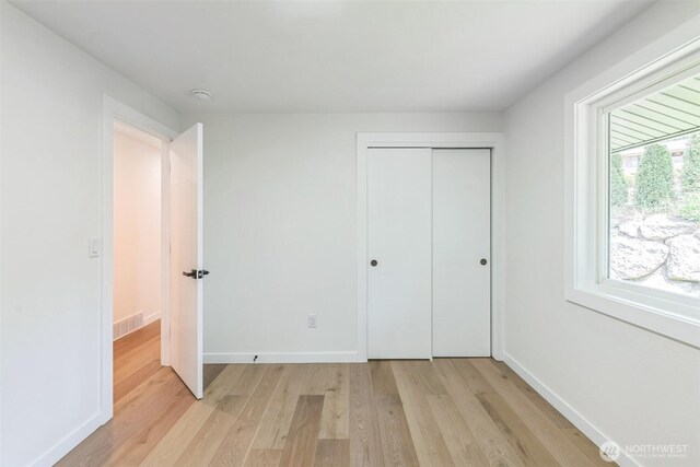 2204 139th Pl SE, Bellevue, WA 98005 - unfurnished bedroom featuring light wood finished floors and a closet