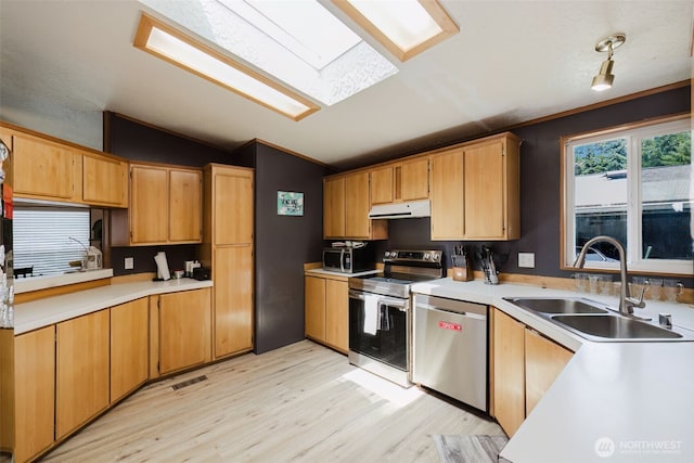 2072 Hastings Ln SE, Port Orchard, WA 98367 - kitchen with appliances with stainless steel finishes, vaulted ceiling, under cabinet range hood, light countertops, and light wood-type flooring