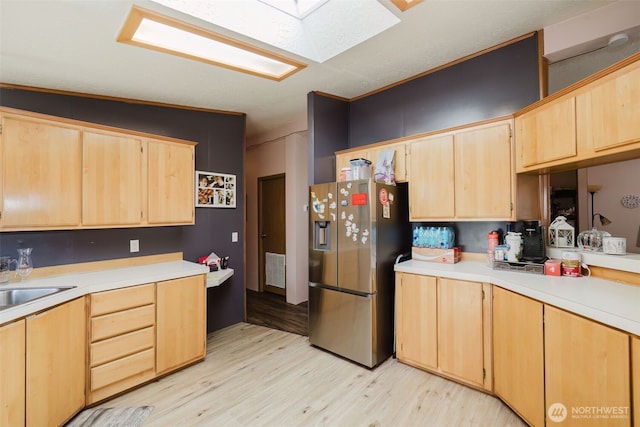 2072 Hastings Ln SE, Port Orchard, WA 98367 - kitchen featuring stainless steel fridge with ice dispenser, light brown cabinets, light wood finished floors, light countertops, and a skylight