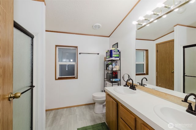 2072 Hastings Ln SE, Port Orchard, WA 98367 - full bathroom with wood finished floors, crown molding, double vanity, and a shower with shower door