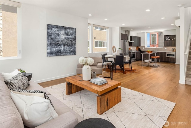 1918 5th Ave N Unit B, Seattle, WA 98109 - living area featuring plenty of natural light, stairway, recessed lighting, and light wood-type flooring