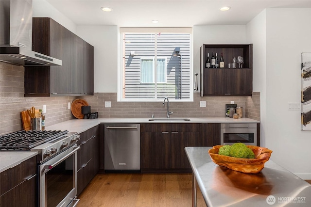 1918 5th Ave N Unit B, Seattle, WA 98109 - kitchen with stainless steel appliances, wall chimney range hood, modern cabinets, and recessed lighting