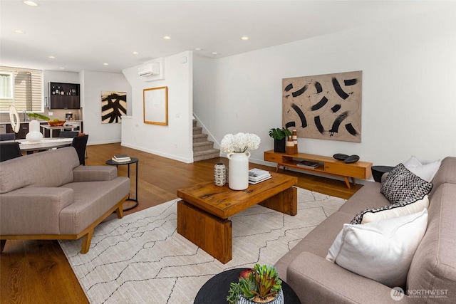 1918 5th Ave N Unit B, Seattle, WA 98109 - living room featuring a wall mounted AC, light wood-type flooring, stairway, and recessed lighting