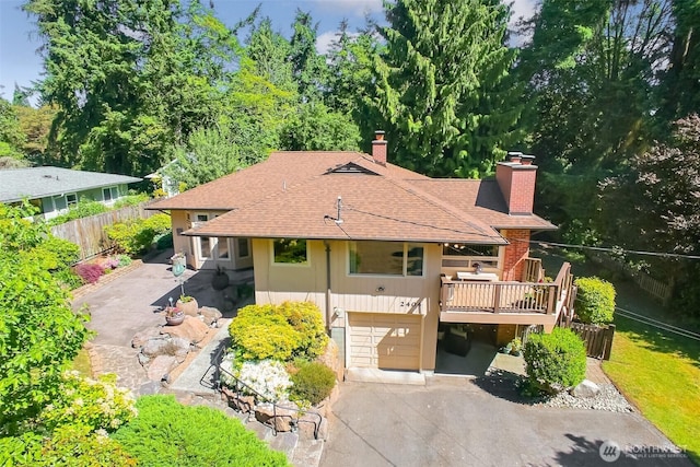 2404 SW 170th St, Burien, WA 98166 - view of front of home featuring a chimney, a garage, driveway, and a shingled roof