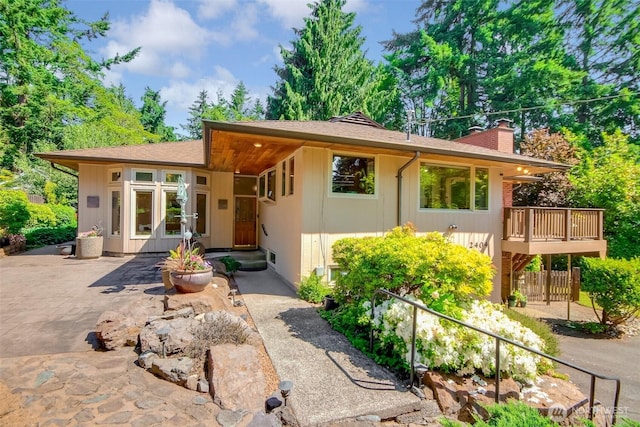 2404 SW 170th St, Burien, WA 98166 - view of front of property with a chimney, a patio, and roof with shingles